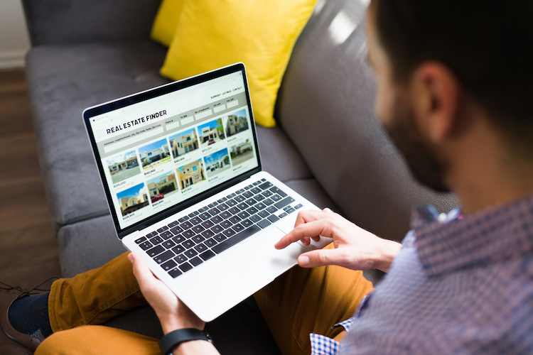 man looking at real estate website