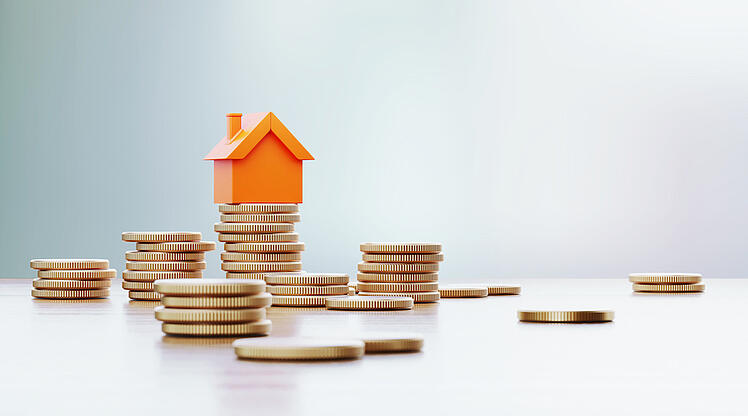 orange house on stacks of coins