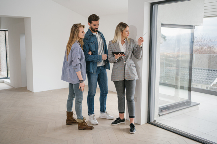 real estate agent showing couple house