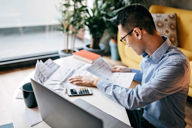 worried man looking at finances